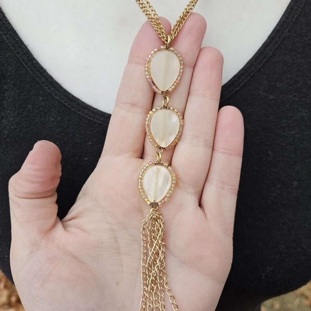 gold tone chain necklace with tiered teardrop tassel pendant